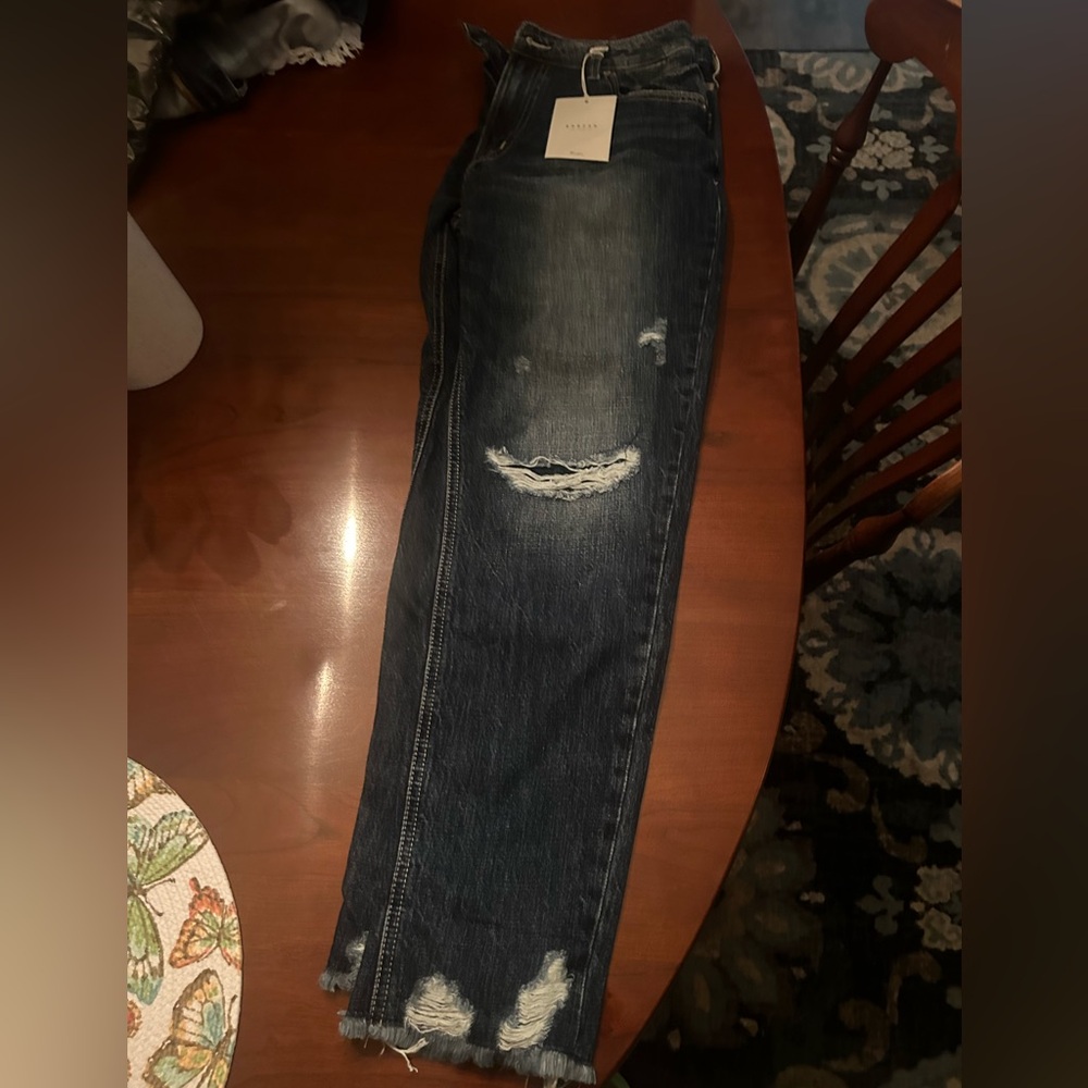 Brand new. Denim jeans with fringe on bottom.